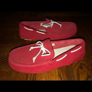 Red Men’s UGG Mocassin with white soles.